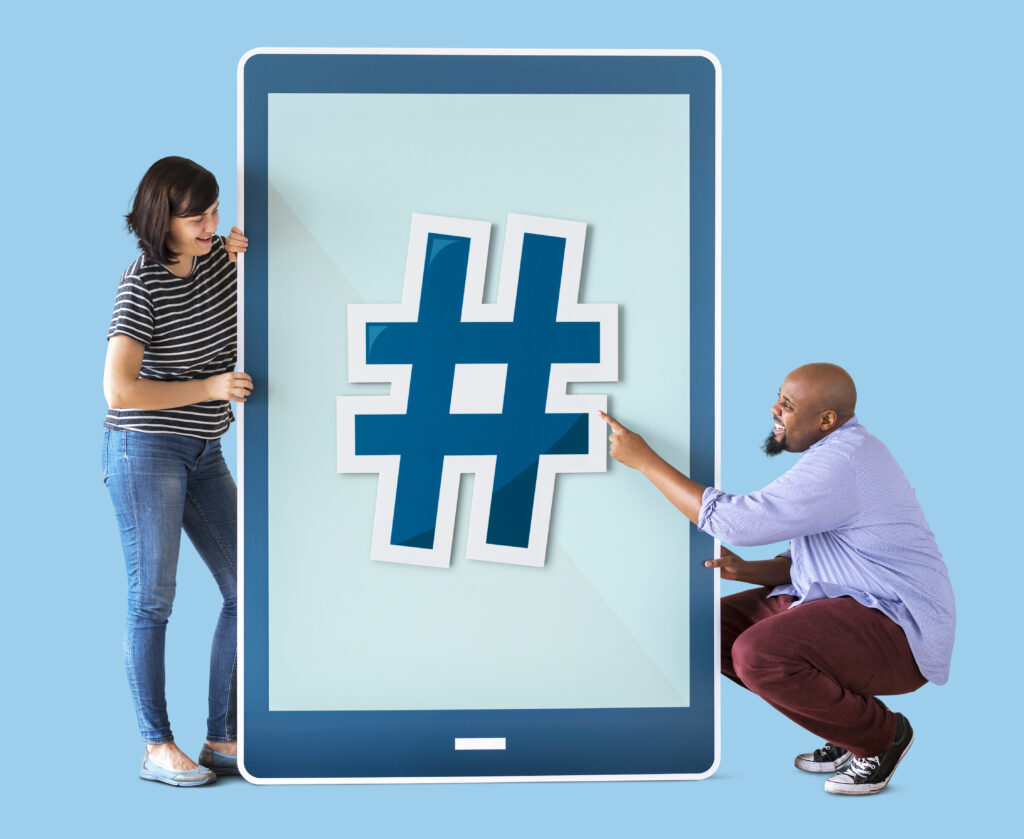 Image of two people looking at hashtags.